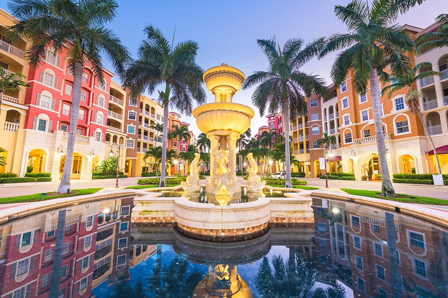 a luxurious fountain in a Naples plaza at dusk