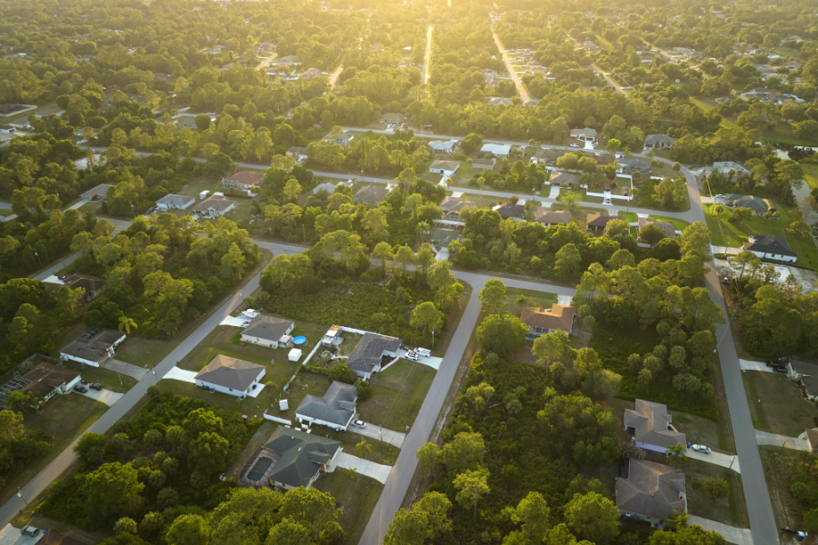 Florida neighborhood landscape at sunset showing large properties of homeowners