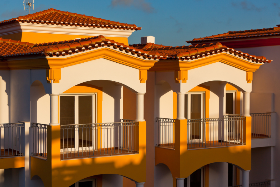 Spanish style home is a popular Naples architecture with it's flatter roof, red tile, and organic colors